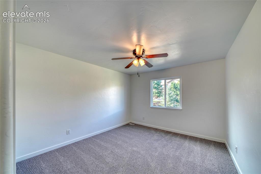 Image 34 of 49: Neutral wall finishes, recessed window, ceiling fan with integrated lightin