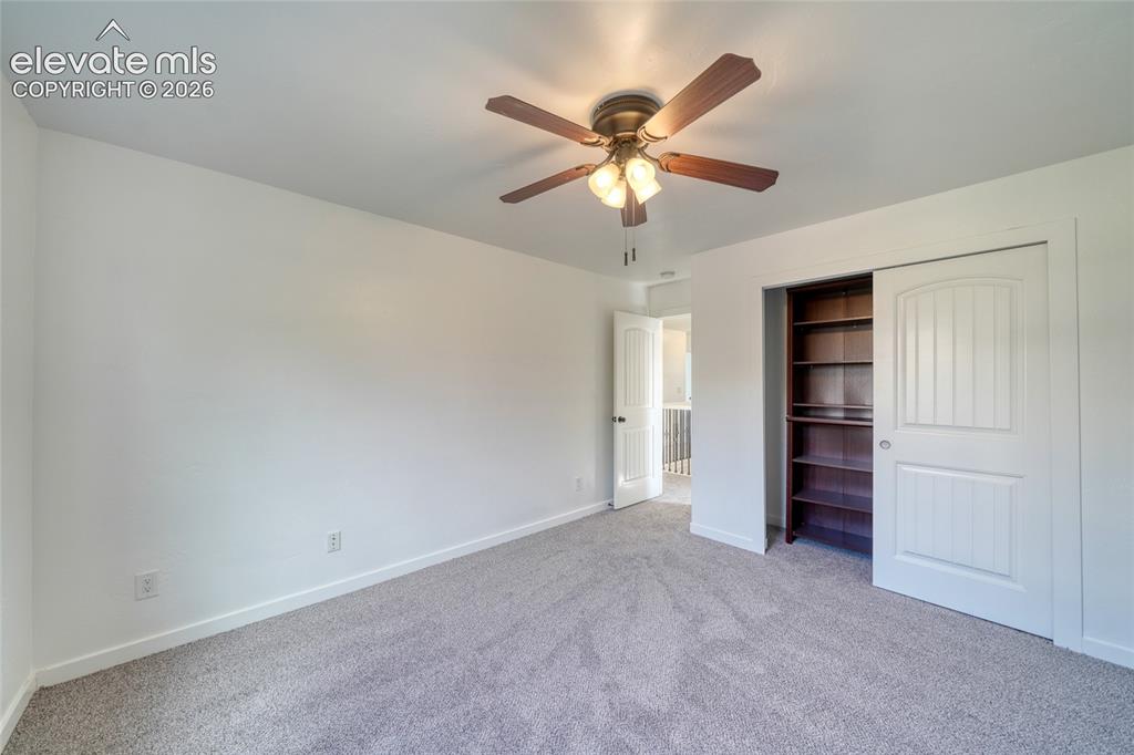 Image 35 of 49: Carpeted room featuring a ceiling fan with integrated lighting, a built-in