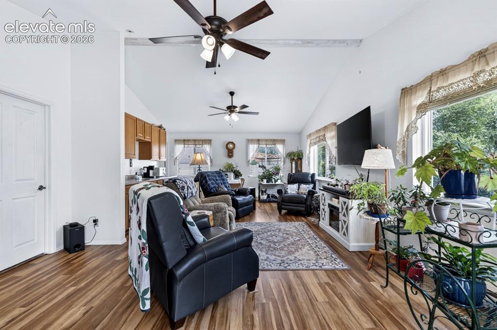 Image 14 of 42: Main Floor- Spacious living area featuring wood-finish flooring, vaulted ce