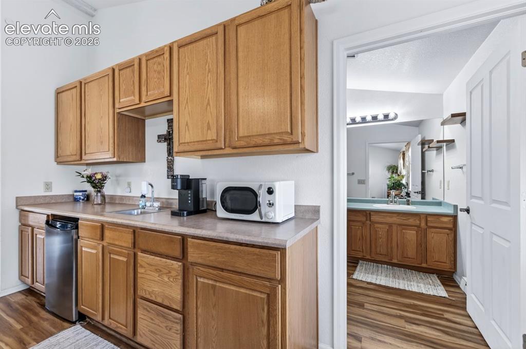 Image 15 of 42: Main Floor- Light wood-finish cabinetry, a built-in sink, and laminate coun