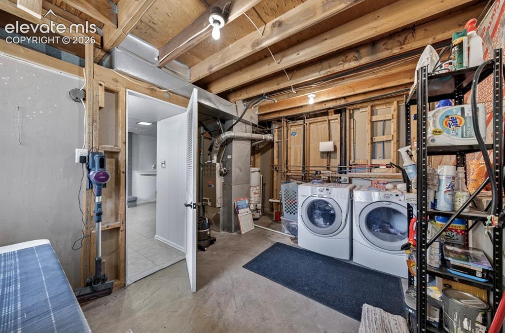 Image 26 of 42: Basement- Laundry area featuring exposed wood ceiling joists and concrete f