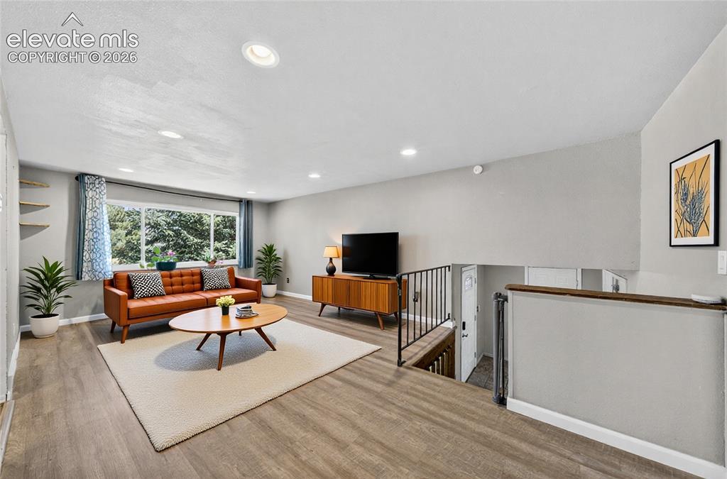 Image 3 of 42: Virtual Staging- Open concept living area featuring hardwood flooring, rec