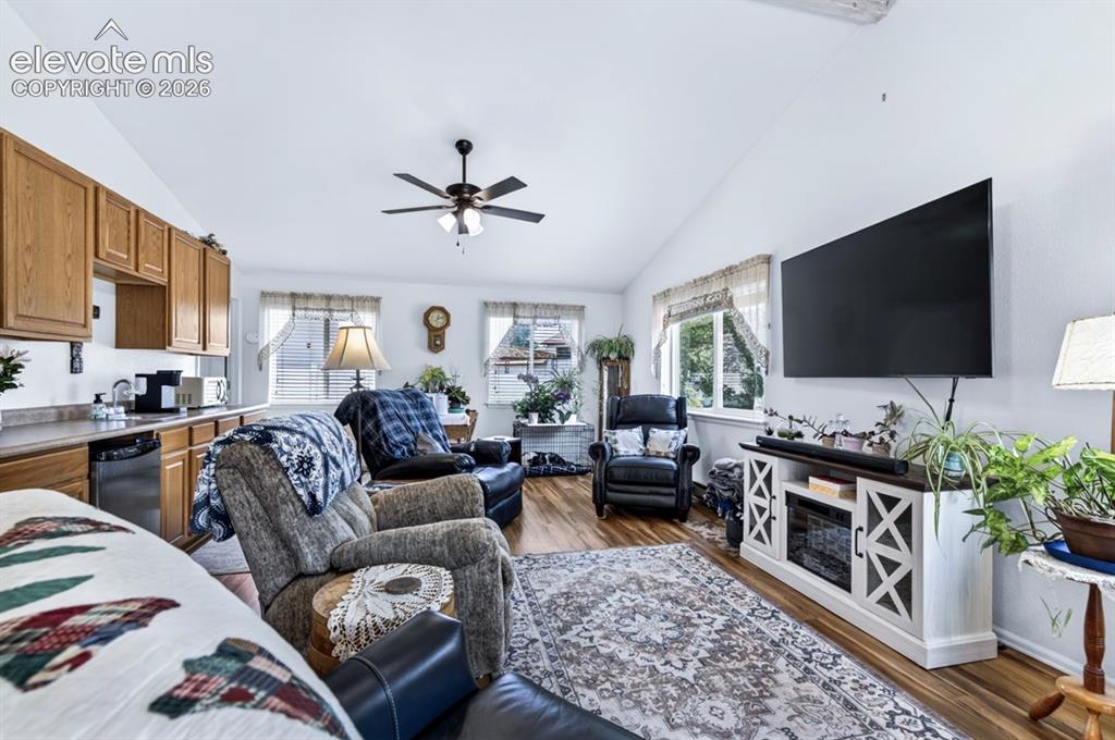Image 6 of 42: Main Level- Open-concept living area featuring vaulted ceilings, wood-finis