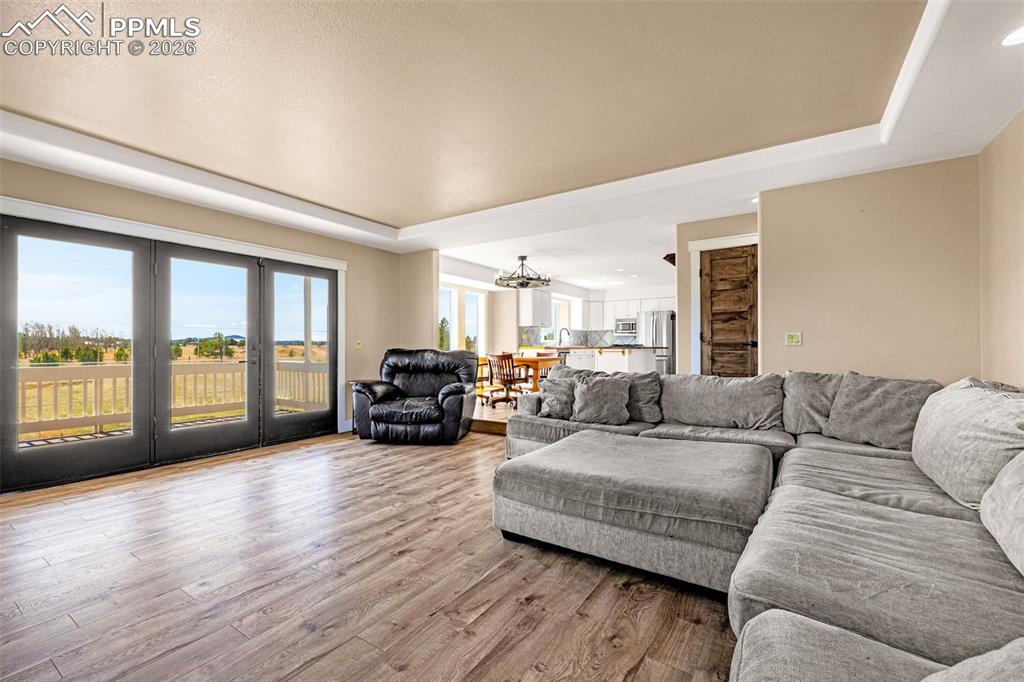 Image 11 of 48: Main level living room, looking towards kitchen