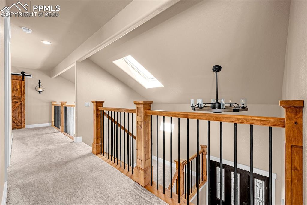 Image 19 of 48: Upper landing w/ beautiful knotty alder & iron