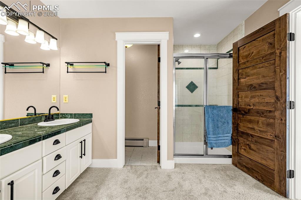 Image 25 of 48: Dual sinks, water closet and free standing shower