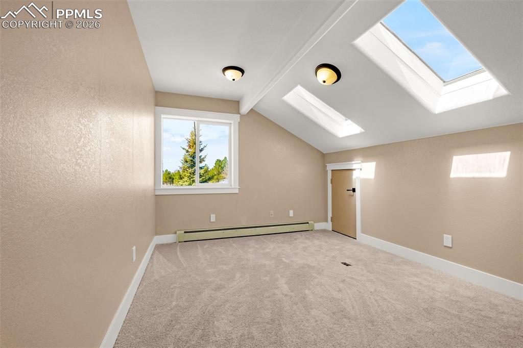 Image 26 of 48: Upper level bedroom #2 featuring skylights