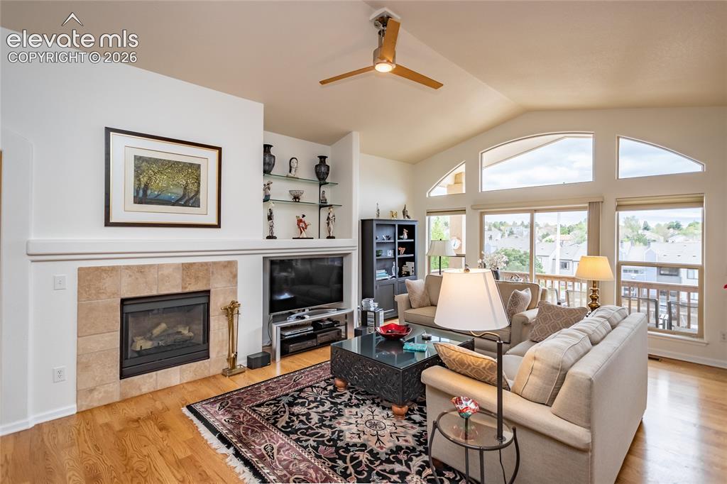 Image 10 of 48: Lots of light & a cozy fireplace too.