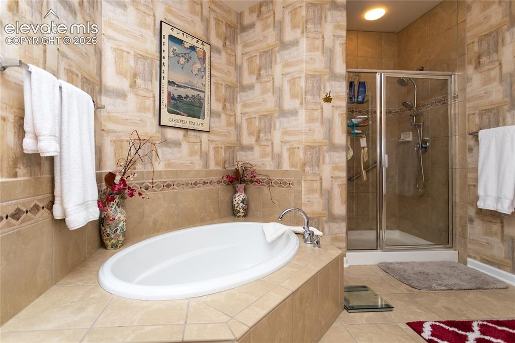Image 23 of 48: Soak all of your cares away & relax your tired muscles or enjoy a steamy sh