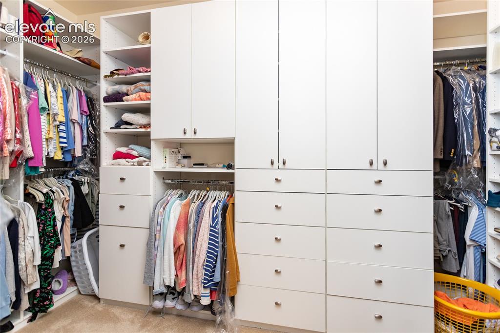 Image 25 of 48: Lots of built-ins in the primary closet....room for everything!
