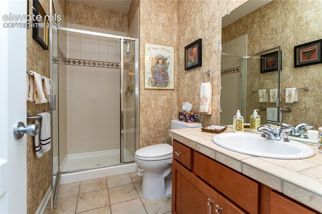 Image 29 of 48: Secondary bathroom is spacious with plenty of storage.
