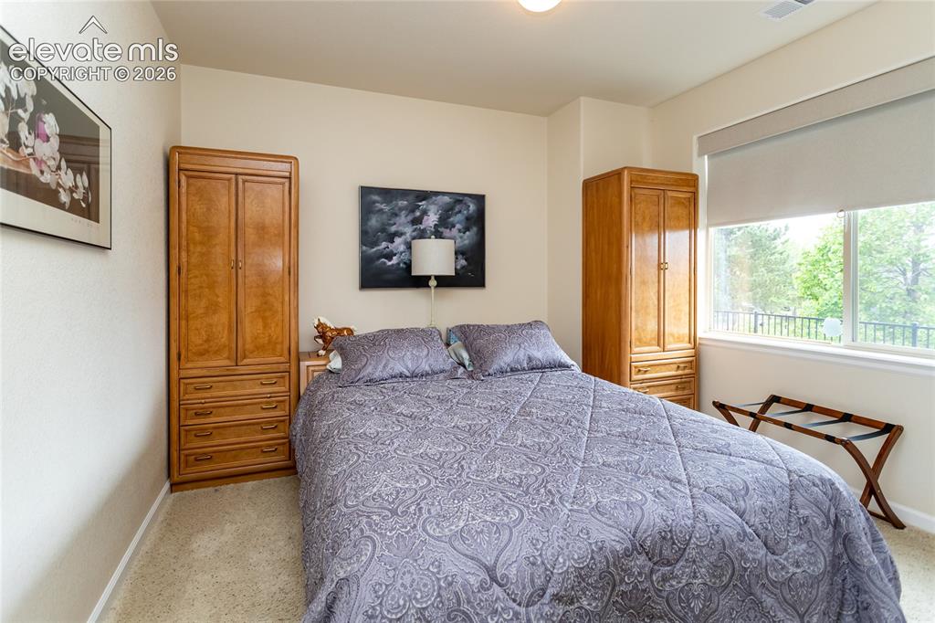 Image 35 of 48: Light filled family or guest bedroom.