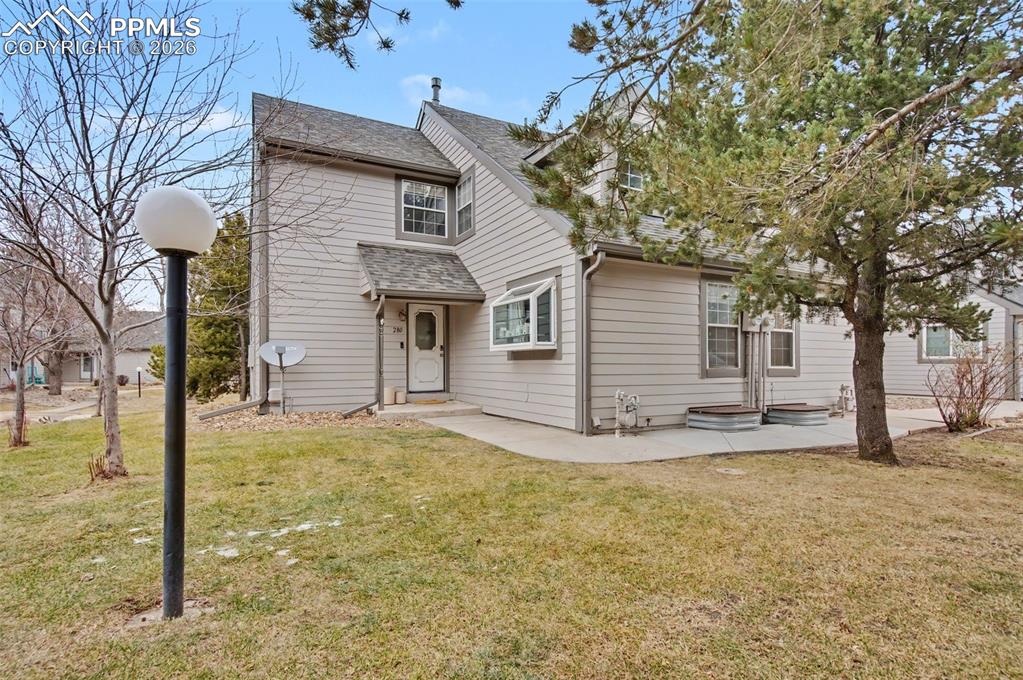 Caption: End-unit Cobblestone townhome with spacious grass area in the front and side of the unit. 