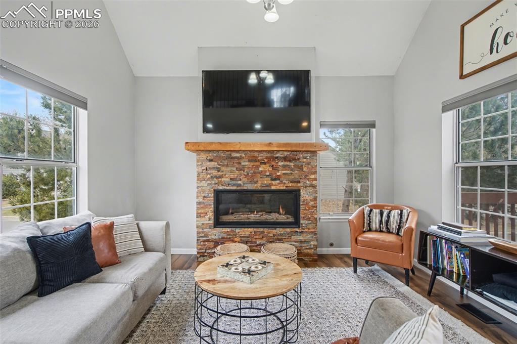 Image 11 of 36: Living room with stacked stone gas fireplace, vaulted ceilings to the loft 