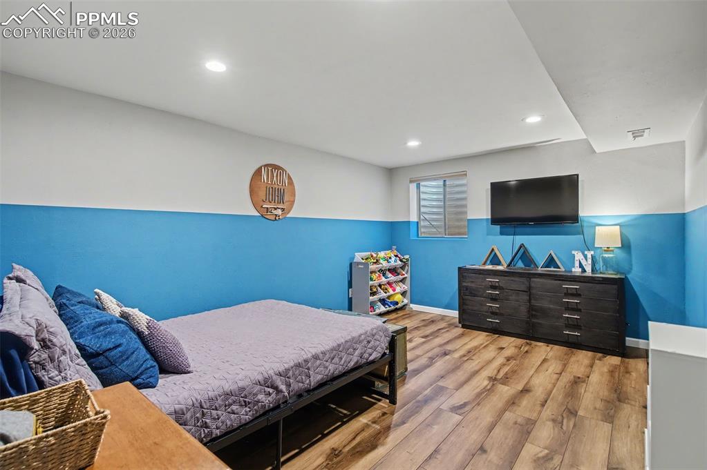 Image 23 of 36: Basement family room (currently used as a bedroom).