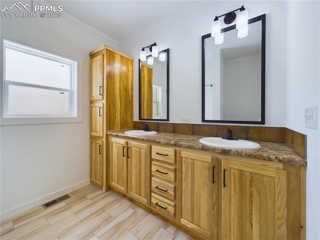 Image 41 of 50: Bathroom tasteful backsplash, and double vanity, linen cabinet, Obscure gla
