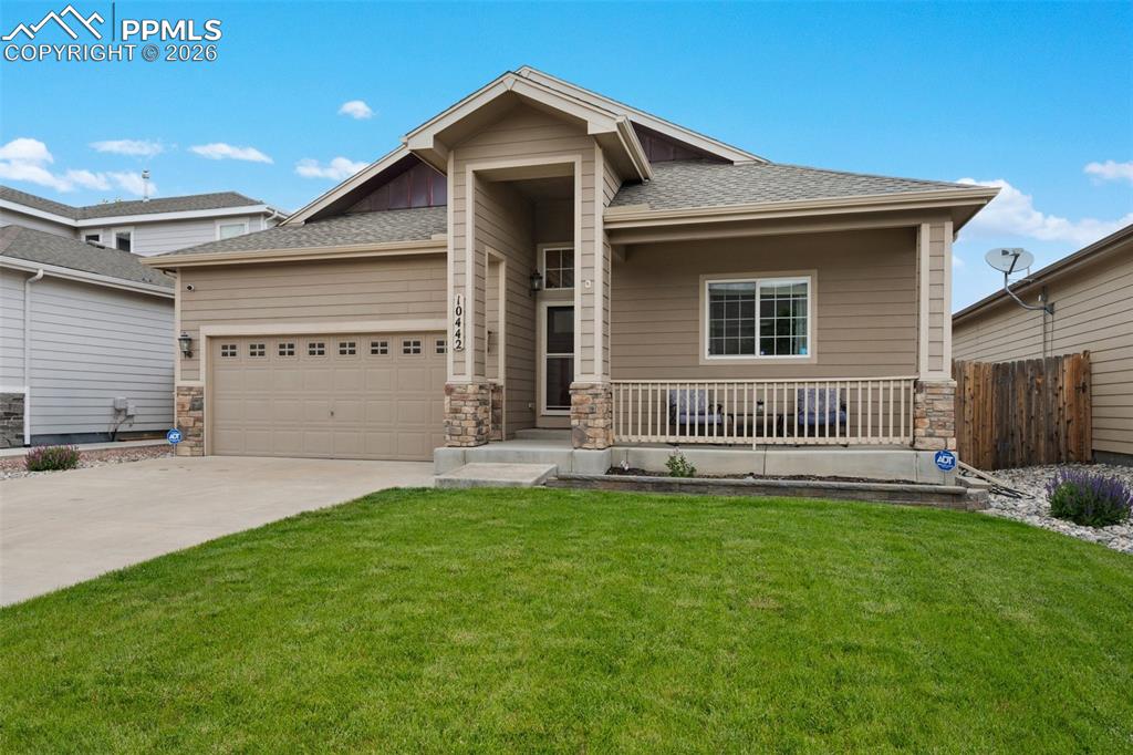 Image 1 of 31: View of front of property with concrete driveway and stone accents