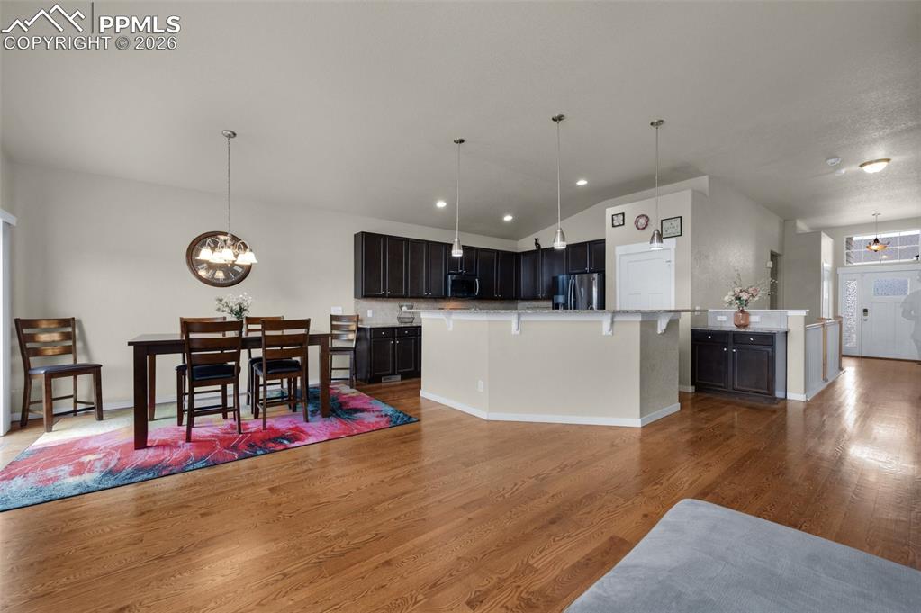 Image 13 of 31: Kitchen and dining area with walk-out to backyard
