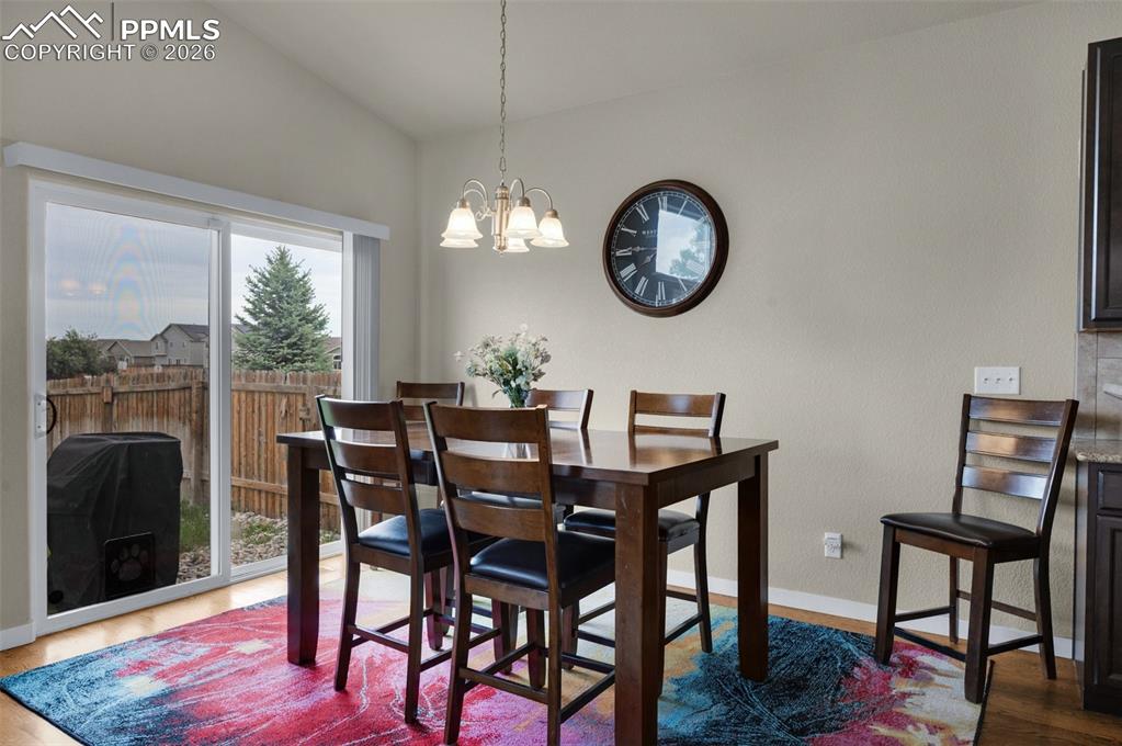 Image 14 of 31: Dining space with plenty of natural light, and vaulted ceiling