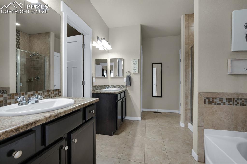 Image 17 of 31: Double vanities, tile flooring, large walk-in closet