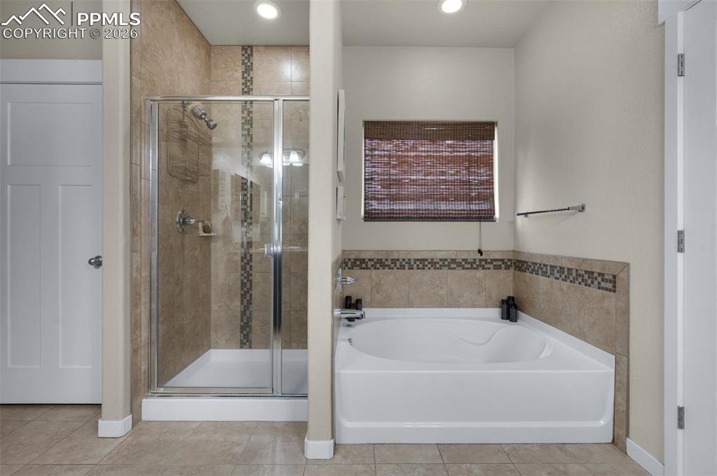 Image 18 of 31: Garden tub, separate shower, and water closet