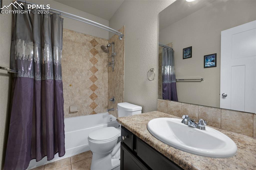 Image 21 of 31: Main level full bath with tile floors