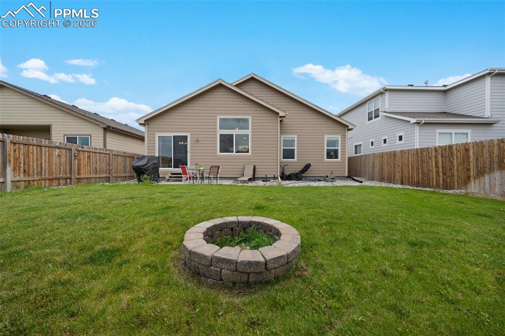 Image 29 of 31: Rear view of property featuring a fire pit and patio area