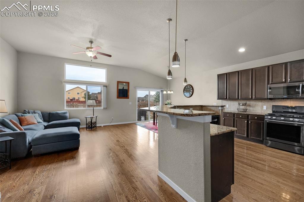 Image 5 of 31: Kitchen featuring stainless steel appliances, open floor plan, a ceiling fa