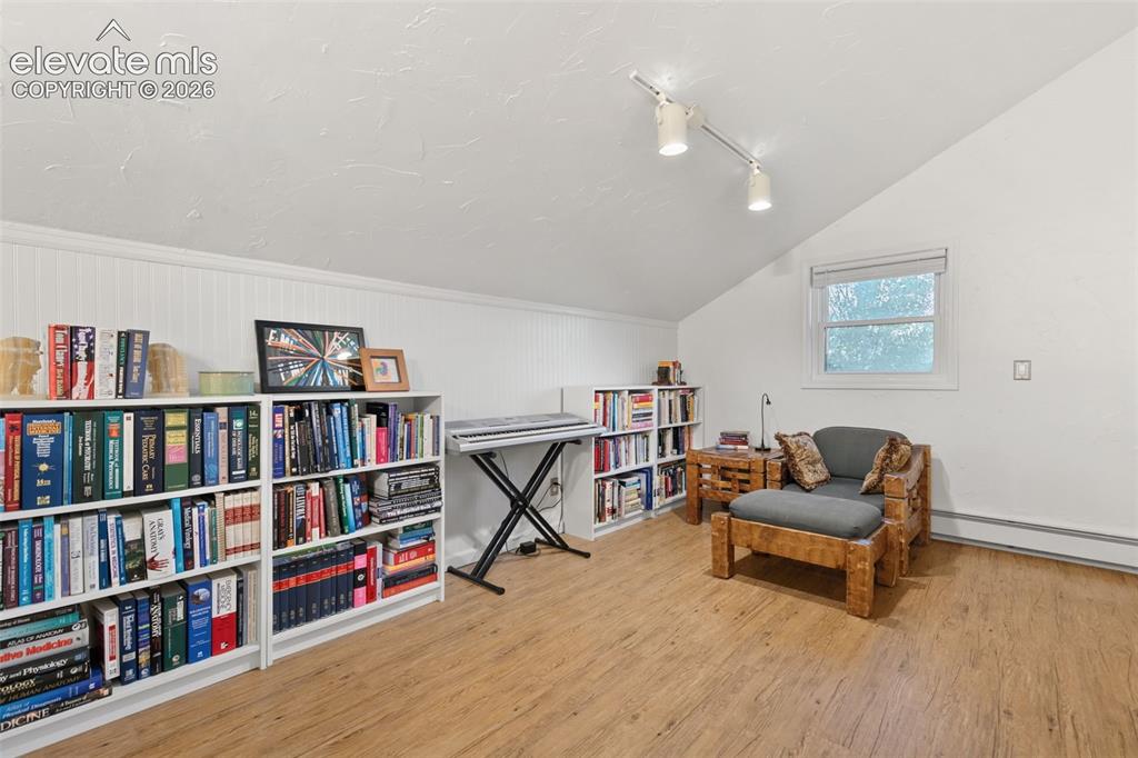 Image 30 of 48: Upper Level TV, office, play room area