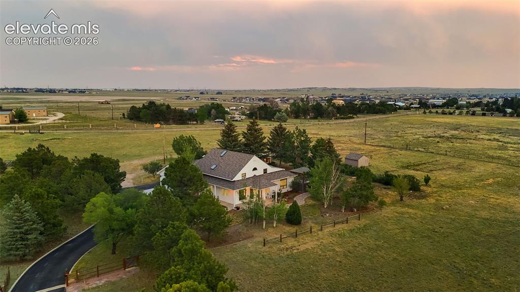 Image 4 of 48: Tree lined front property line and gated driveway