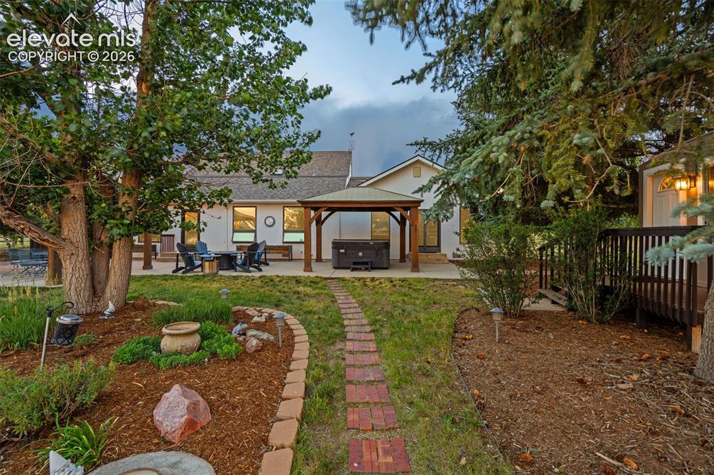 Image 42 of 48: HUGE patio with 2 gazebos, hot tub, planter boxes