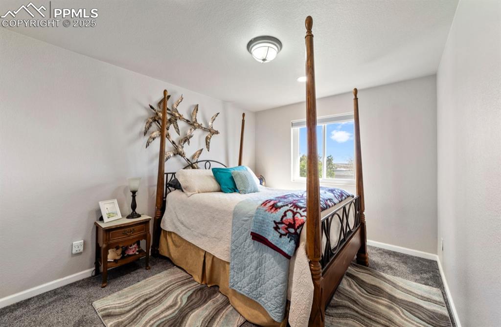 Image 13 of 21: Bedroom featuring baseboards and carpet flooring