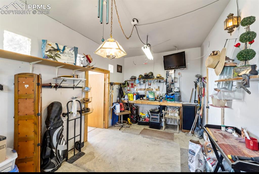 Image 17 of 21: Garage with a workshop area