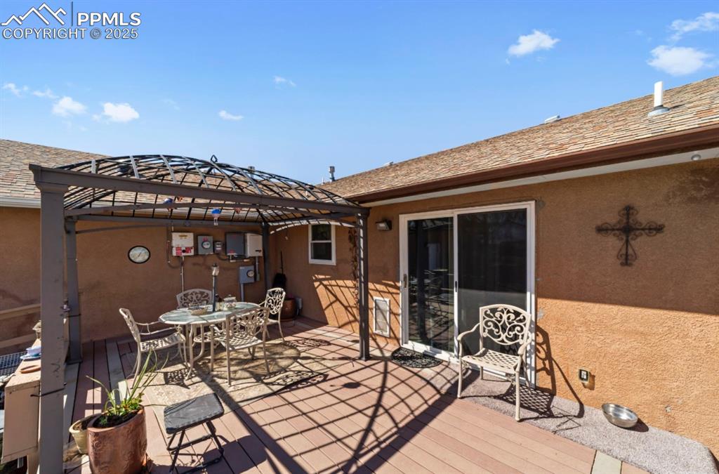 Image 19 of 21: Wooden deck featuring a gazebo and outdoor dining space