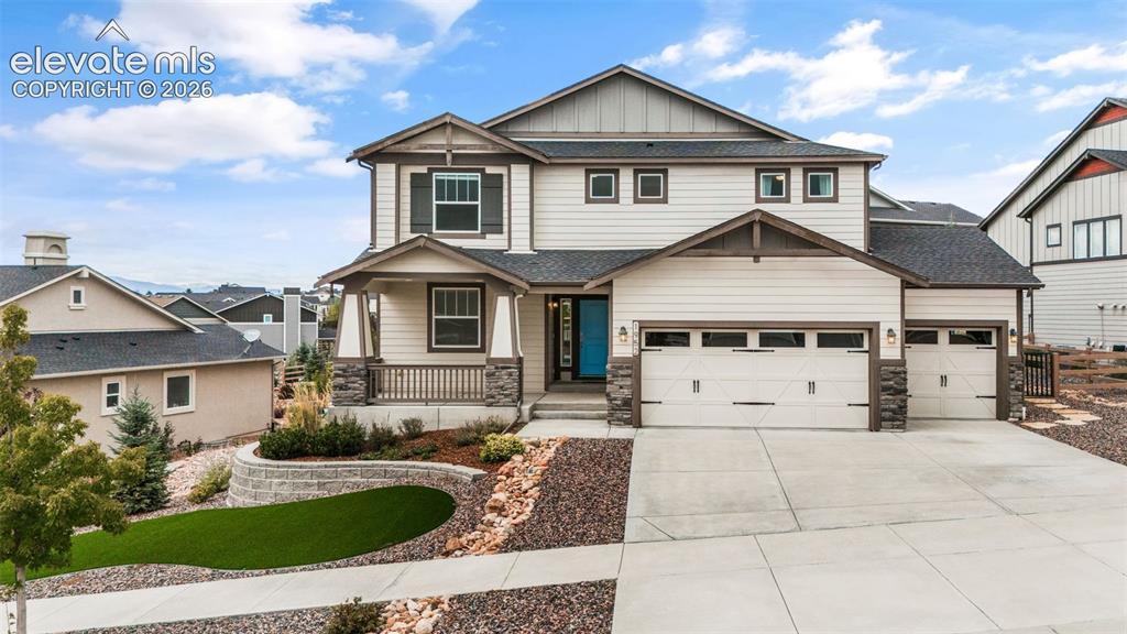 Caption: Two-story single family residence featuring a covered front porch, stone veneer accents, and an atta