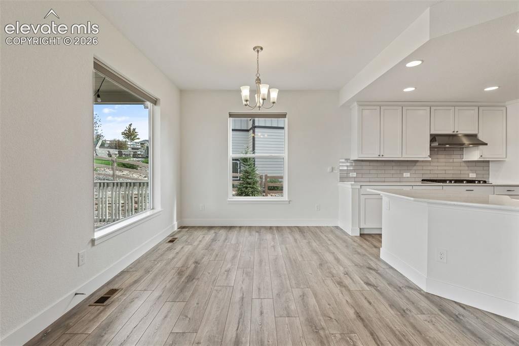 Image 10 of 50: Breakfast nook attached to the kitchen and living room 
