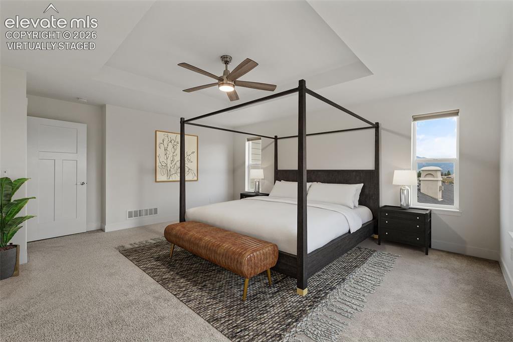 Image 23 of 50: Virtually staged: Recessed ceiling with a central fan, light gray carpeting