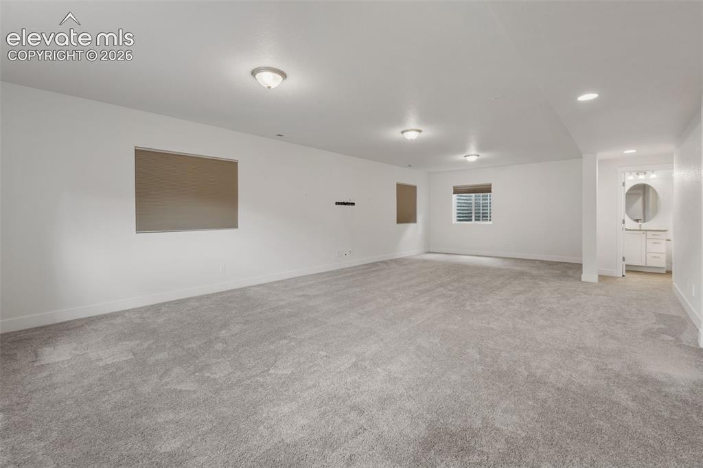 Image 35 of 50: Spacious finished lower level featuring recessed lighting, light gray carpe