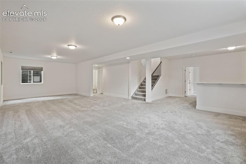 Image 36 of 50: Spacious finished lower level featuring recessed lighting, light gray carpe