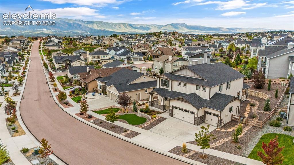 Image 43 of 50: Exterior with a Three-car garage, stone accents, and a landscaped front yar