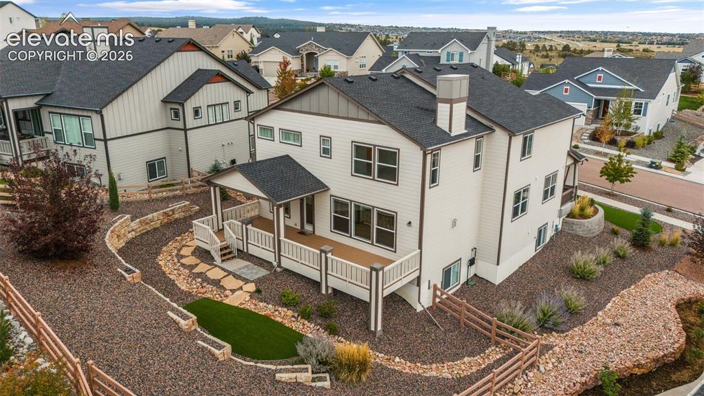 Image 44 of 50: Rear exterior featuring a deck with partially covered patio, and stepped ha