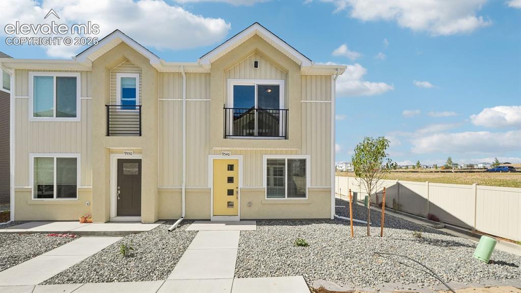 Image 1 of 28: Light-toned vertical siding with contrasting trim details, balcony with bla