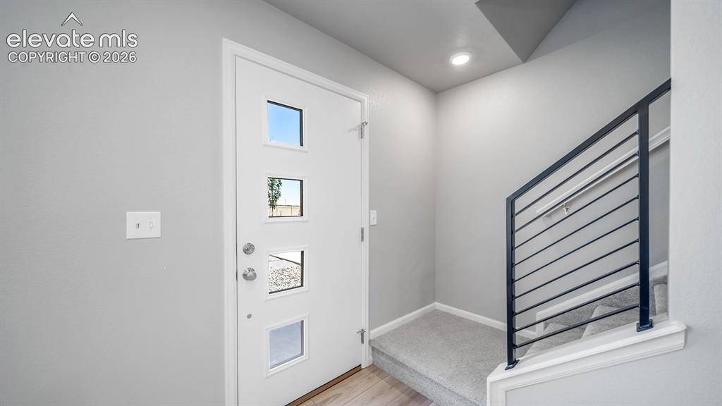 Image 13 of 28: Entryway featuring a contemporary white door with multiple square lites and