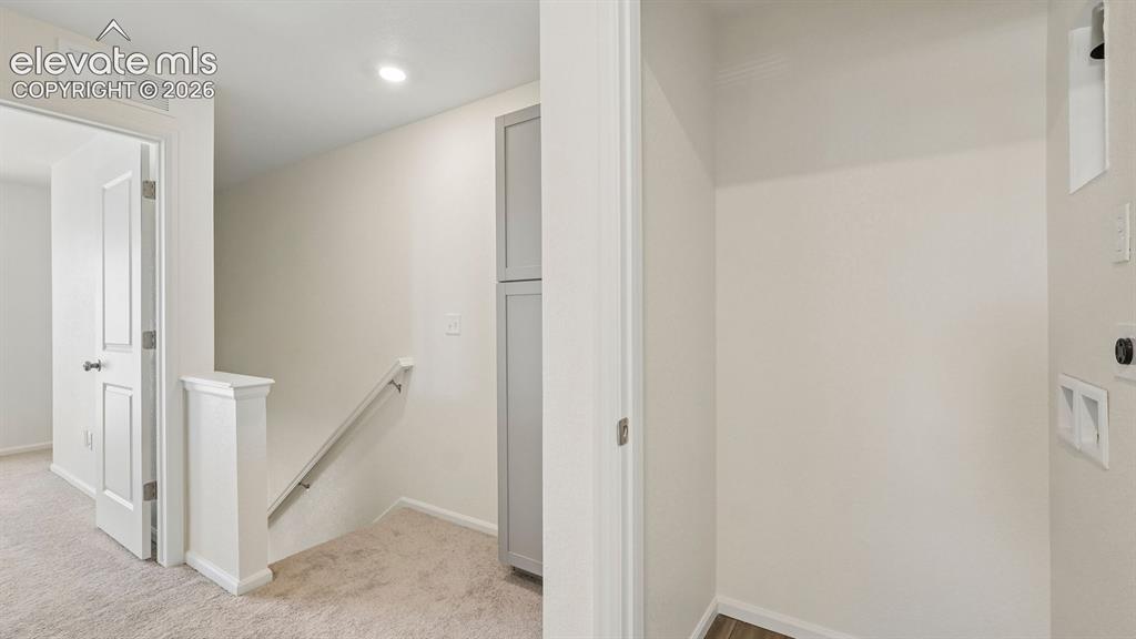 Image 18 of 28: Built-in cabinetry, recessed lighting, and carpeted flooring