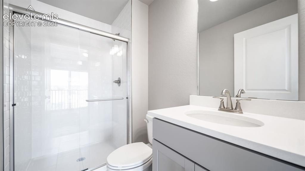 Image 22 of 28: Bathroom featuring a single vanity with a white countertop and gray cabinet