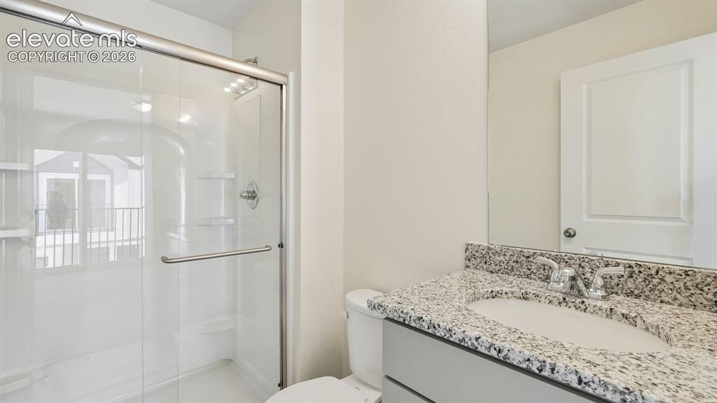 Image 23 of 28: Glass-enclosed shower with chrome fixtures