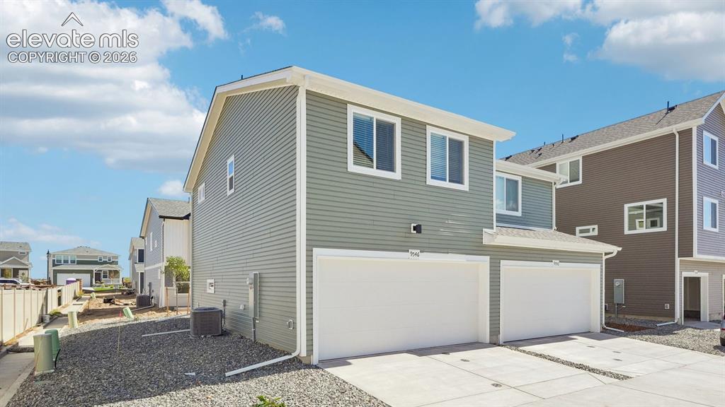Image 26 of 28: Two-story exterior with light green siding and white trim