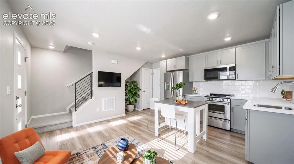 Image 4 of 28: Open-concept living space with light wood-finish flooring
*Photos of a mod