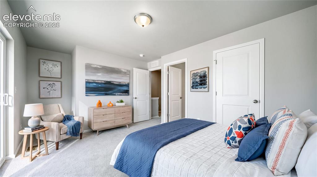 Image 6 of 28: Carpeted bedroom featuring light gray walls, a ceiling-mounted light fixtur
