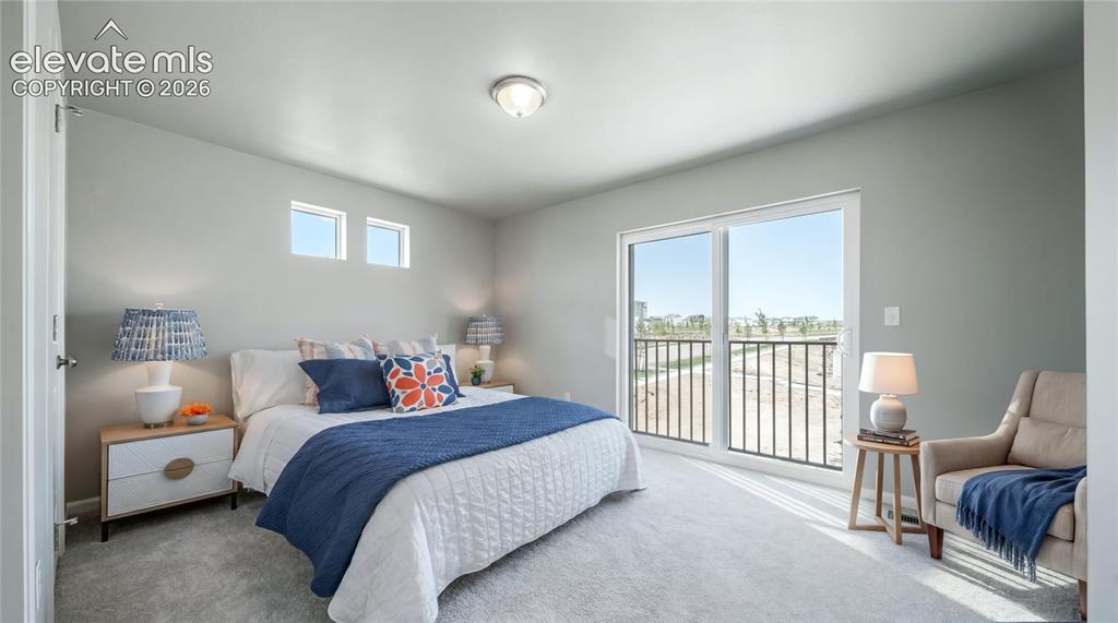 Image 7 of 28: Bedroom featuring light gray wall paint, recessed ceiling light, two transo